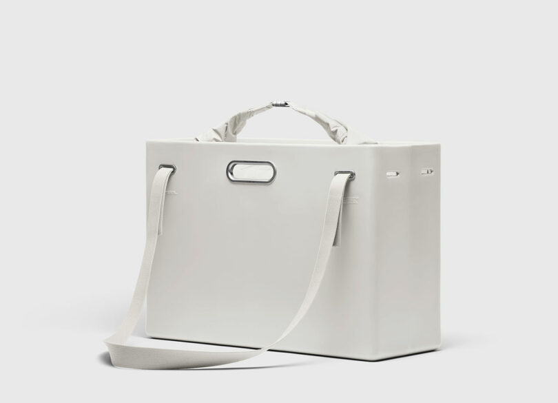 A rectangular white PARSEL EVA Tote System bag with a shoulder strap, metal handle, and minimalist design, shown against a plain light background.