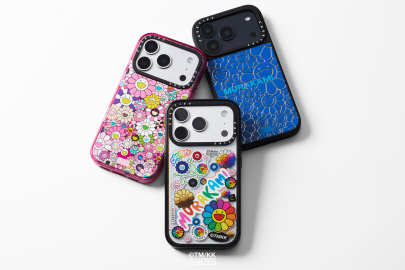 Three smartphones with Murakami-inspired floral and graphic cases in pink, blue, and clear designs, arranged on a white surface.