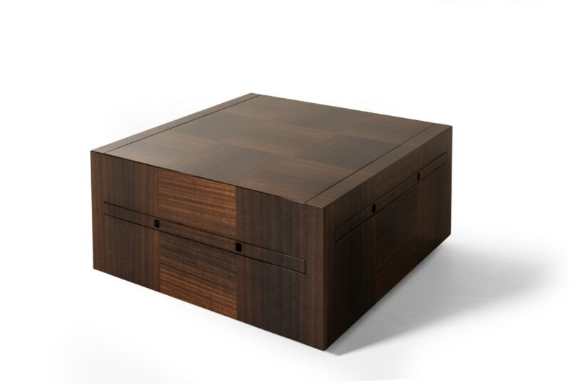 A square, closed wooden box with a checkered grain pattern, set against a plain white background