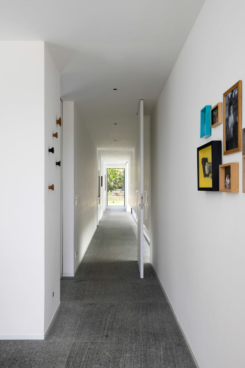 interior shot down long white hallway of modern house