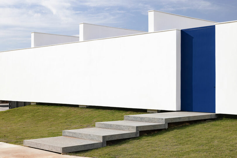 partial front exterior view of white rectilinear house