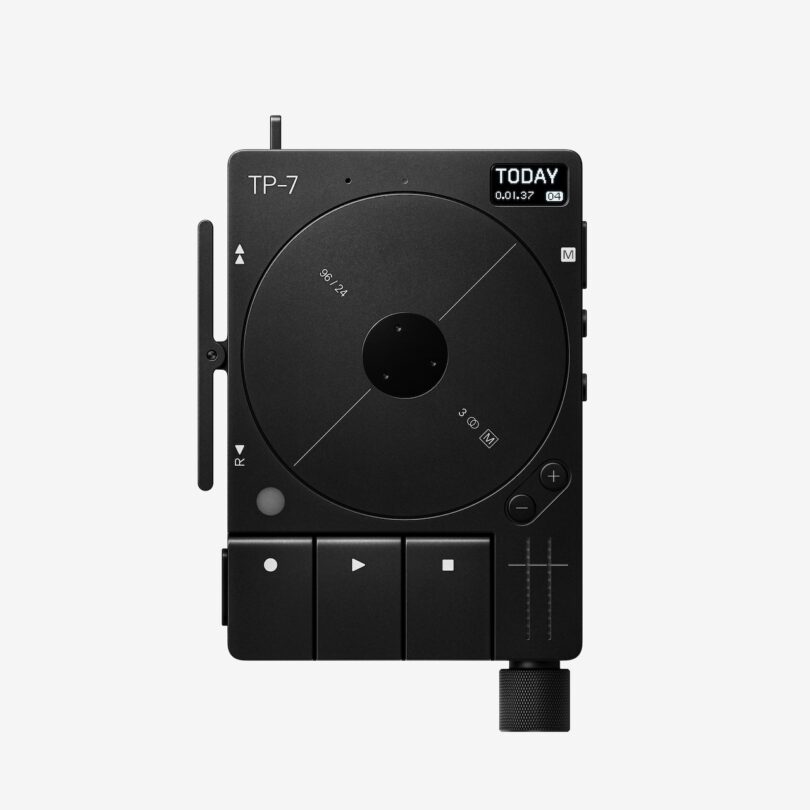 A black portable audio recorder with circular dial, buttons for playback and recording, display screen showing “TODAY,” and knobs and sliders, photographed on a white background.