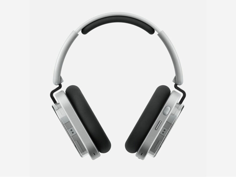 Silver over-ear wireless headphones with black ear cushions and a cushioned headband, showcasing sleek technology against a plain white background.
