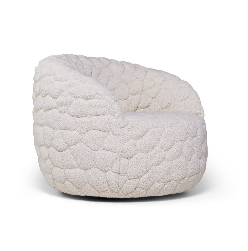A rounded, low-profile armchair upholstered in textured, off-white fabric with a pebble-like pattern.