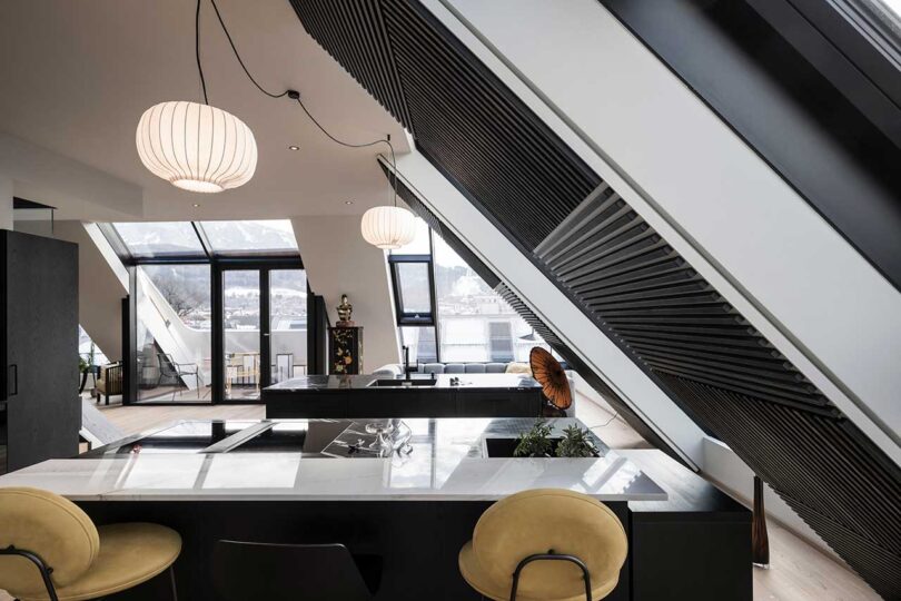 modern apartment interior with slanted glass walls